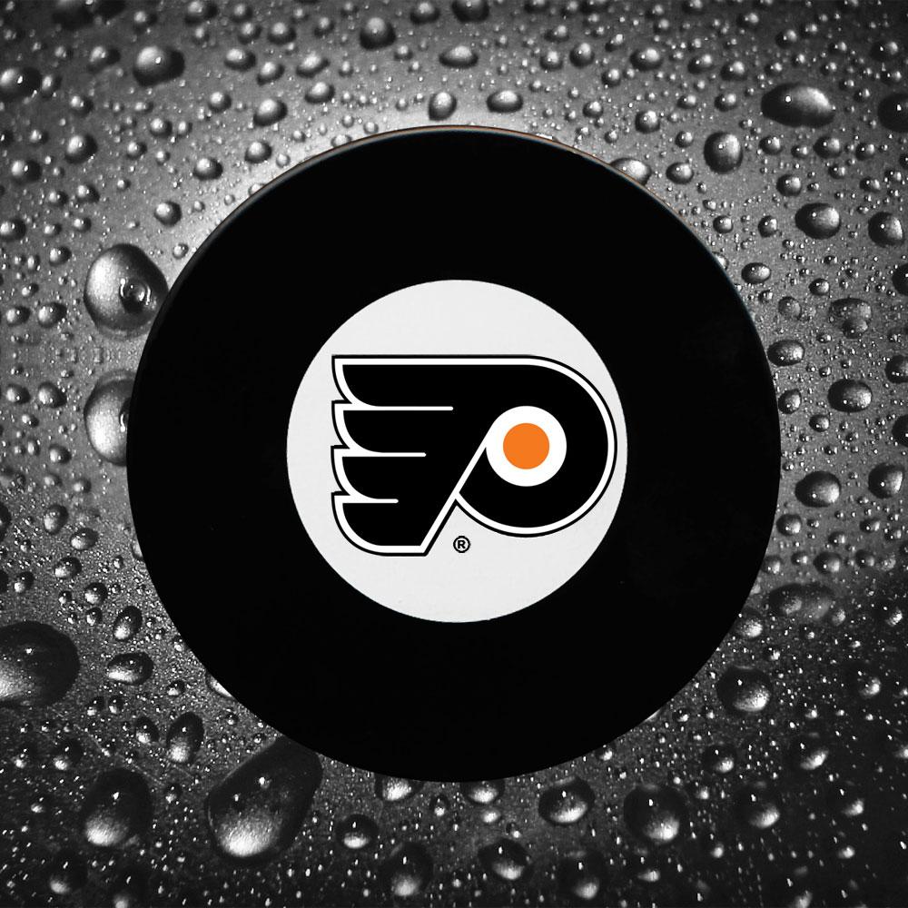 Dave Schultz précommande une rondelle dédicacée des Flyers de Philadelphie